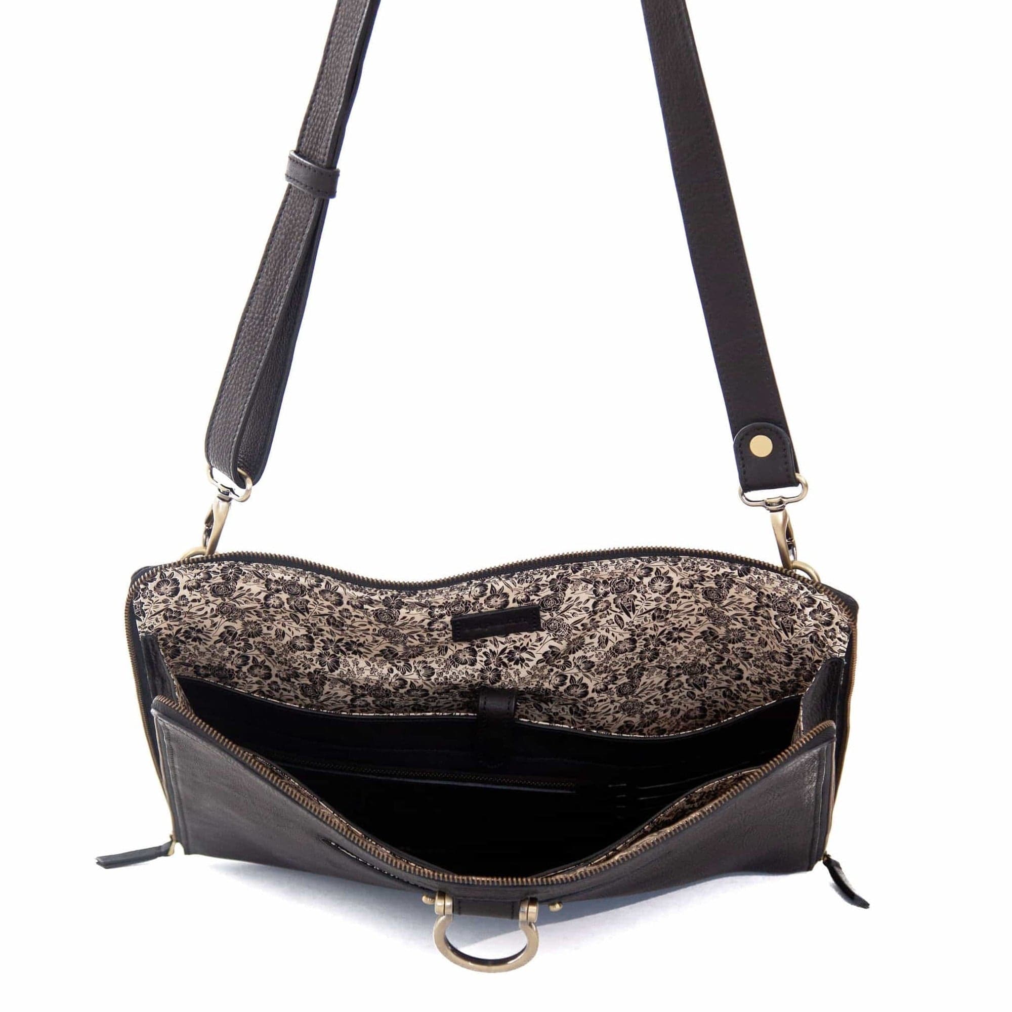 The M large crossbody bag in black raw leather will hold your 13” laptop in a scratch-resistant interior sleeve.