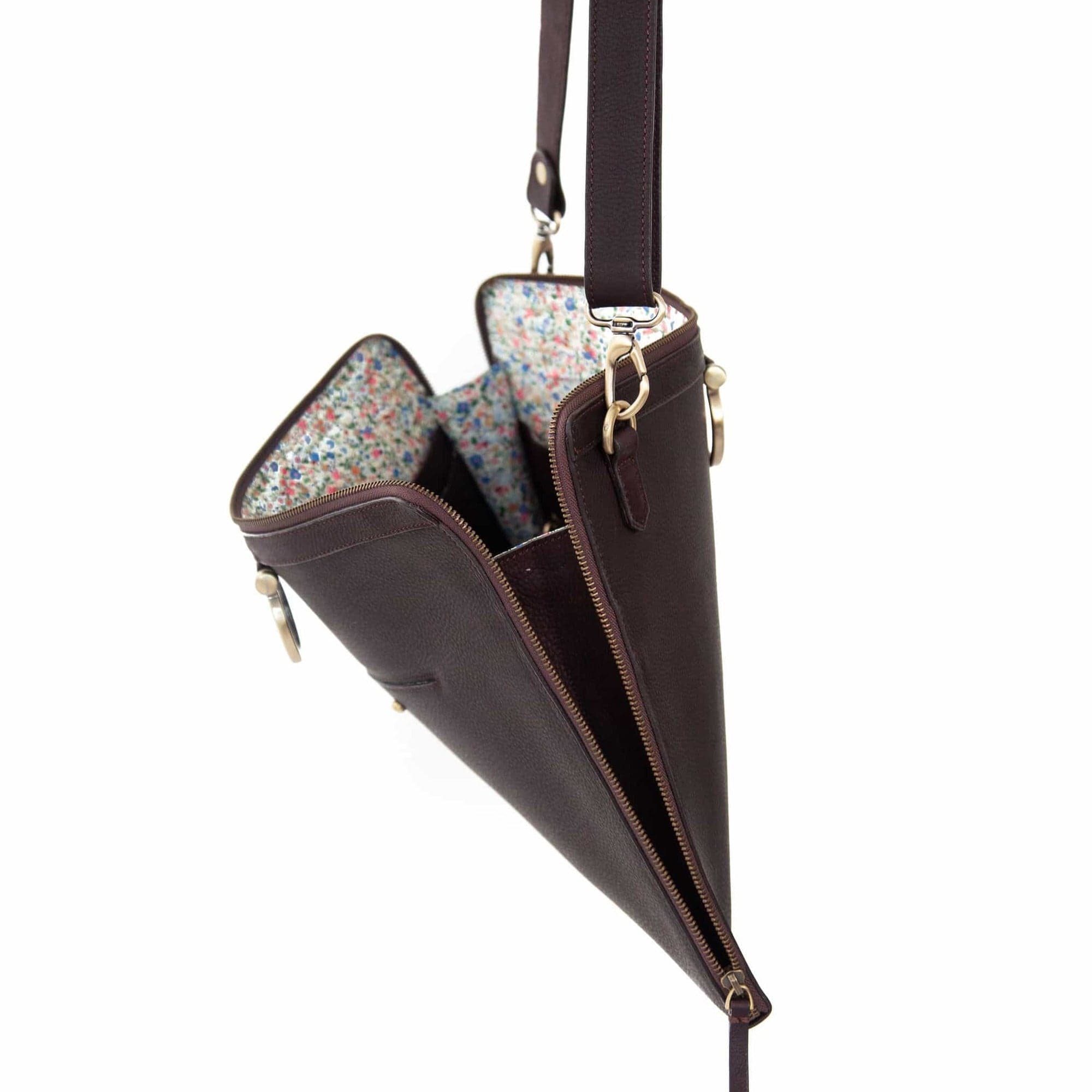 The M large crossbody bag in chocolate brown raw leather zips all the way around for a sleek, minimalist look.