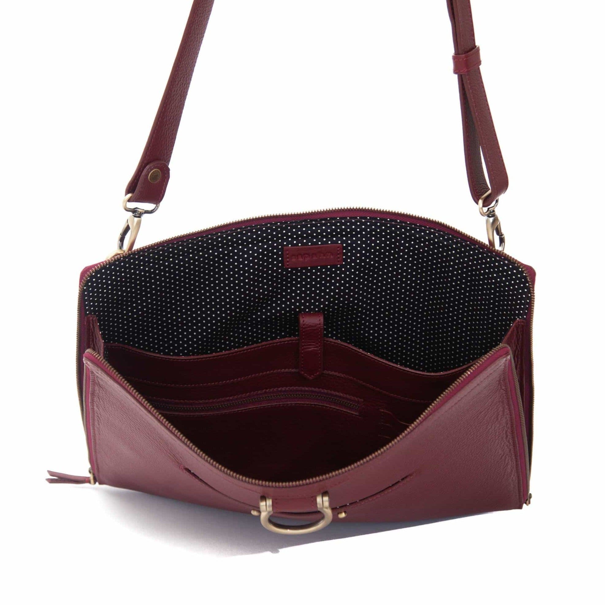 The M XL crossbody bag in deep red oil leather will hold your 15” laptop in a scratch-resistant interior sleeve.