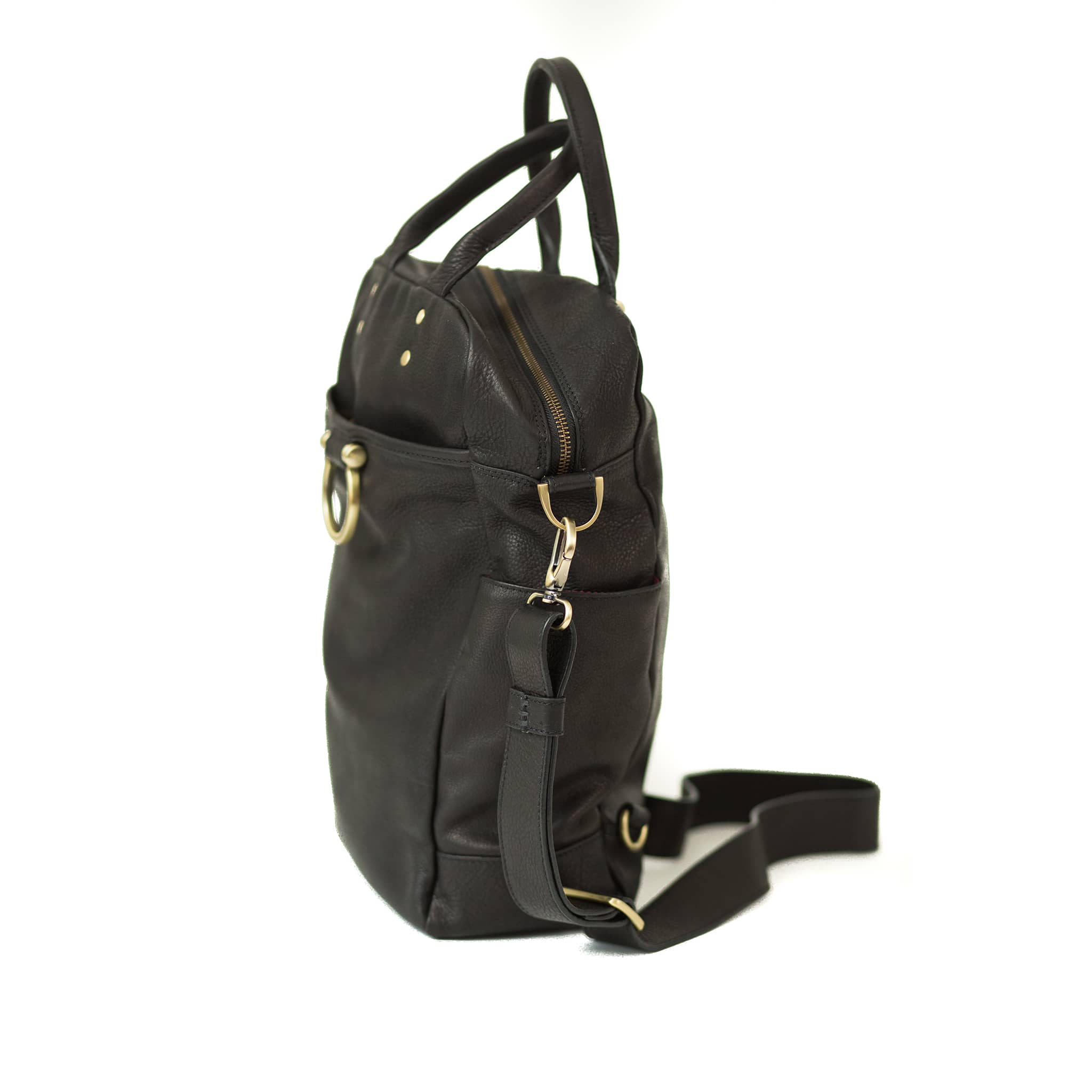 The Rodica leather crossbody bag in black raw leather has convenient exterior pockets for organization.