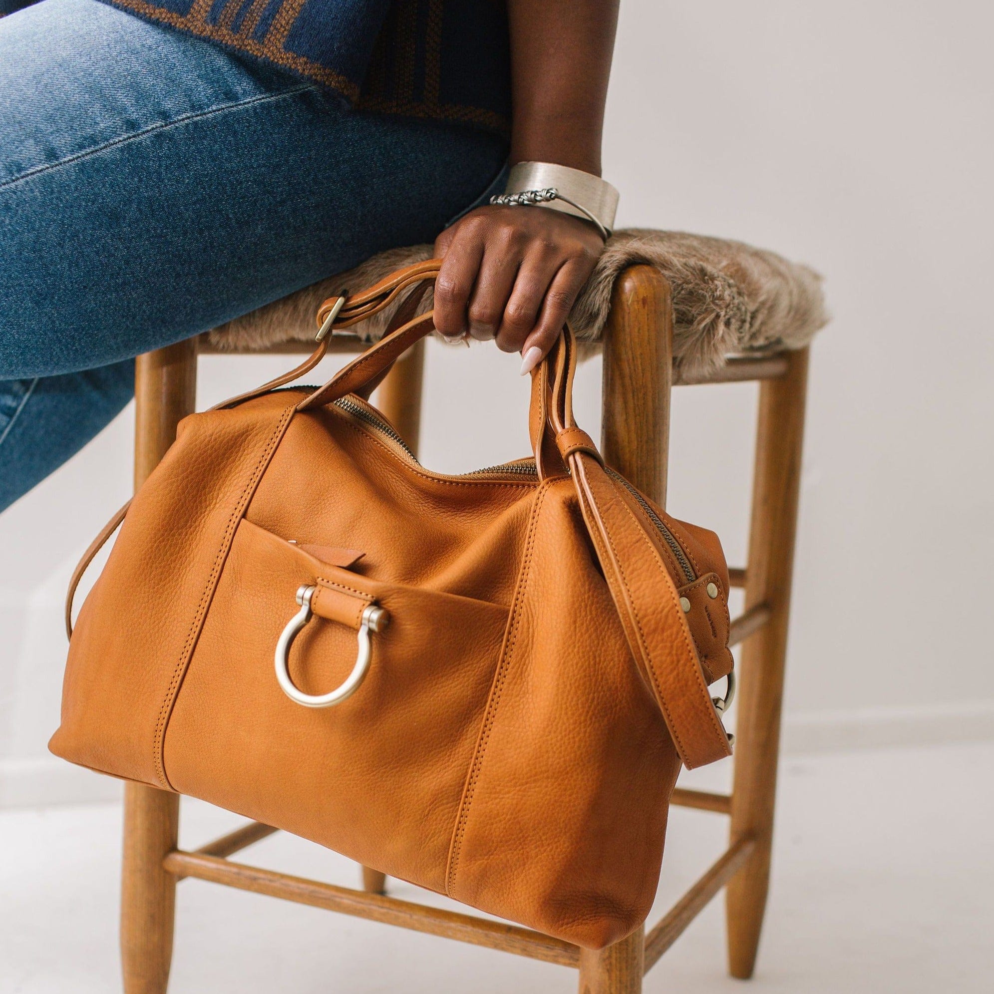 Linda Jean handbag in whisky tan raw leather can be carried by the top straps.