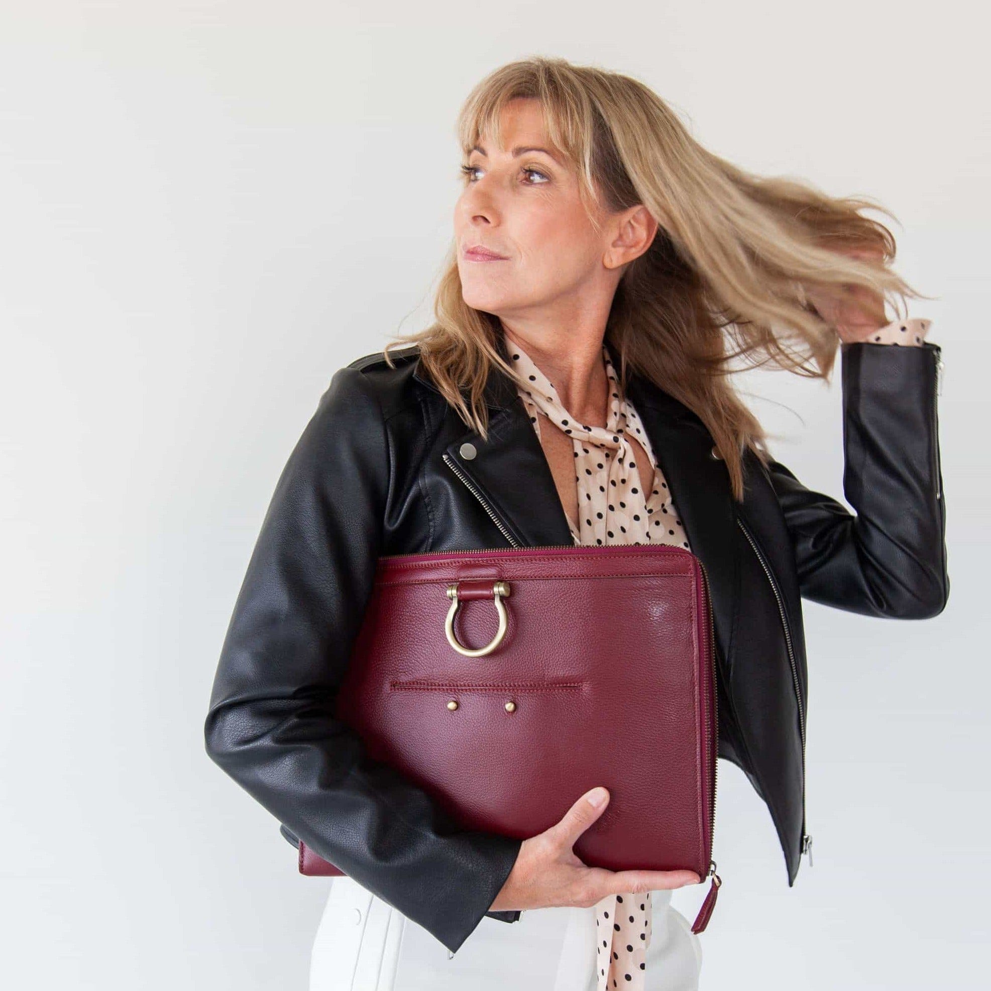 Carry the M large crossbody bag in deep red oil leather like a clutch.