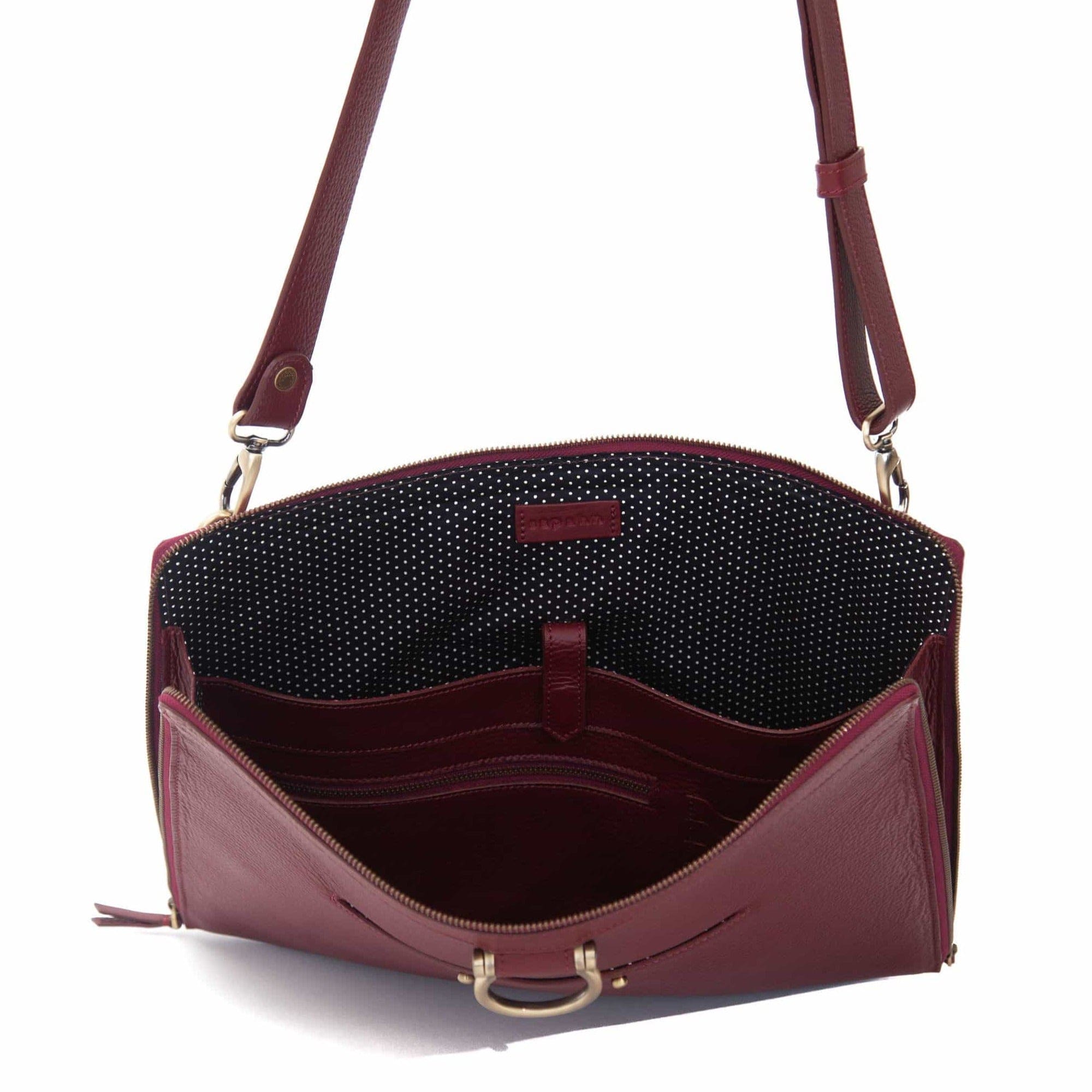 The M large crossbody bag in deep red oil leather will hold your 13” laptop in a scratch-resistant interior sleeve.