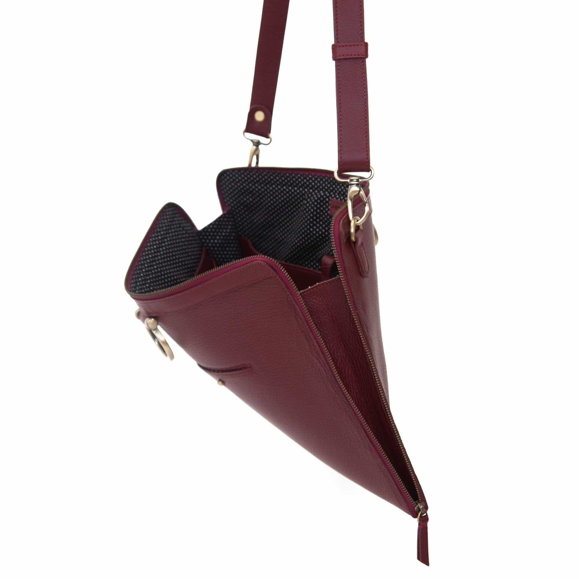 The M large crossbody bag in deep red oil leather zips all the way around for a sleek, minimalist look.