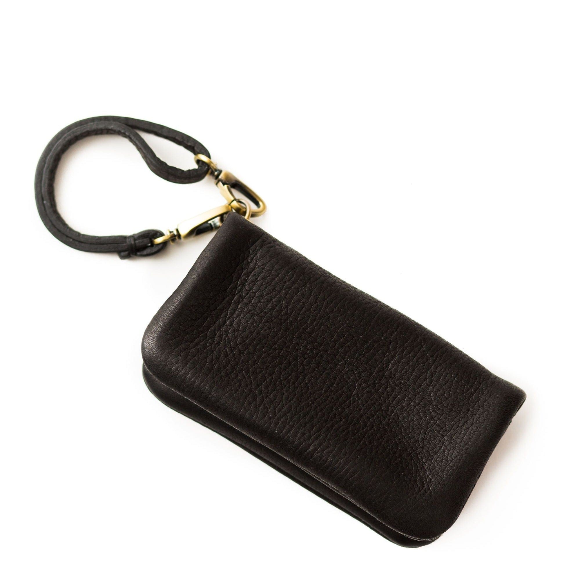 The Woo card holder in black raw leather is sleek and minimal and can be used as a wallet, wristlet, or keychain addition.